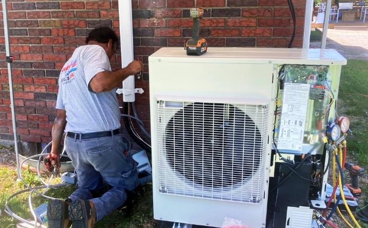 A Jack Lehr Heating, Cooling & Electric working on a HVAC System