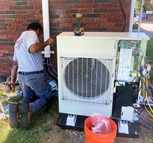 A Jack Lehr Heating, Cooling & Electric working on a HVAC System